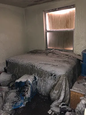 Bedroom damage by fire, smoke, soot and water